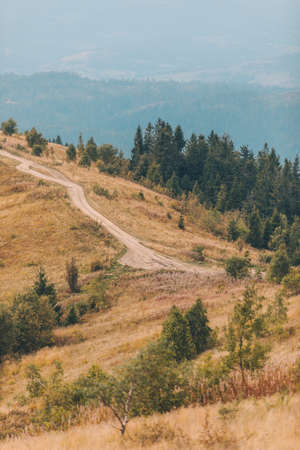 trail road in mountains autumn landscape viewの写真素材