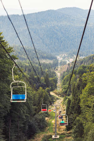 summer mountains travel chair road lift up to the peak