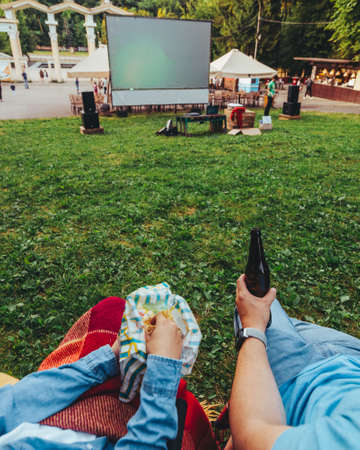 eating snacks drinking beer movie in open air cinemaの写真素材