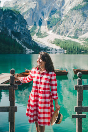 portrait of smiling gorgeous woman at boat station. mountain lake on backgroundの写真素材