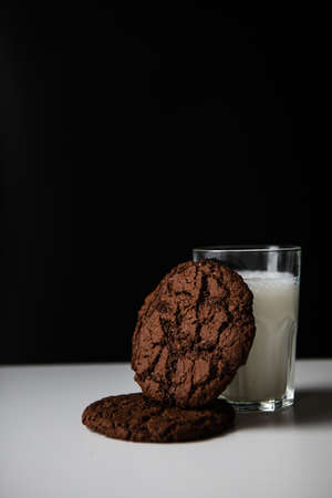 pouring milk in glass with chocolate cookies. copy spaceの写真素材