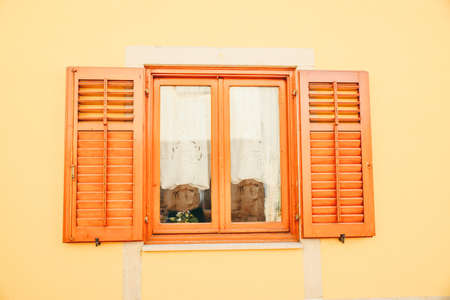 view of brown wooden window with shutters