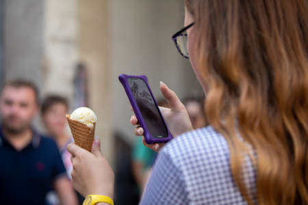 woman taking picture of ice cream on her phone