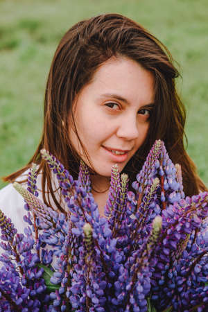 woman at blooming lupines field
