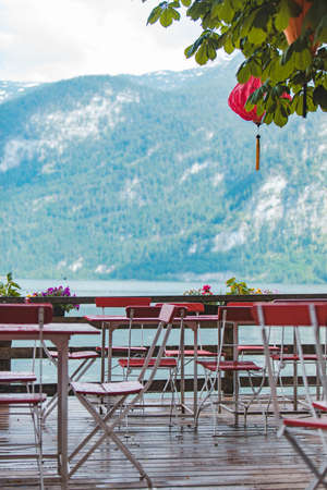 view of empty tables and chairs in outdoors cafe summer time