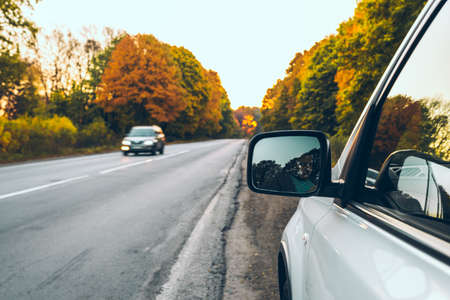 car at roadside of highway on sunrise autumn highwayの写真素材