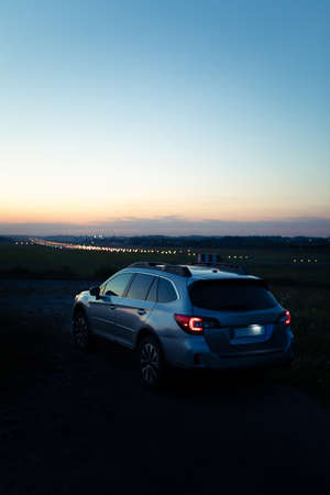 car taillights at night time. city lights on background. copy spaceの写真素材