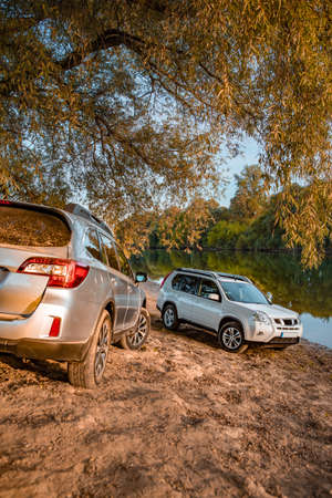 two cars parked at autumn river beach