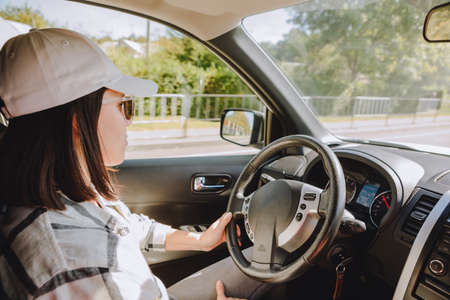 young pretty driver woman sitting in car view from inside