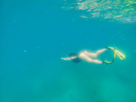 woman in snorkeling mask and flippers under water summer beach vacationの写真素材