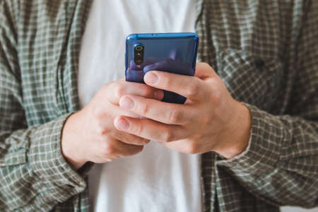 smiling man portrait using mobile phone