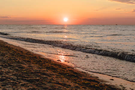 view of sunrise above the sandy sea beach. copy spaceの写真素材