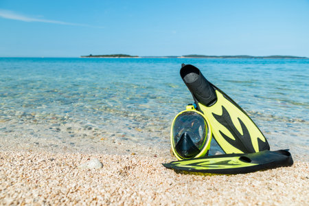 snorkeling mask with flippers at sea beach. summer time, vacation concept. copy spaceの写真素材