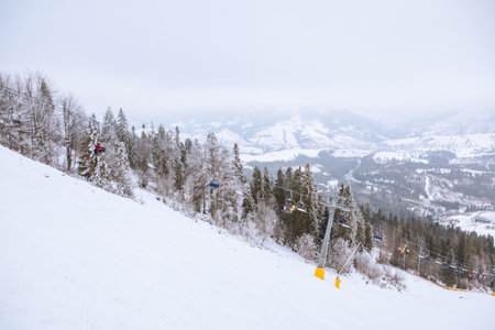 view of ski resort lift mountains in fogの写真素材