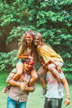young happy friends at holi fest