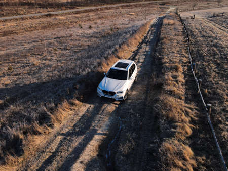 overhead top view of the suv car going by trail road copy space