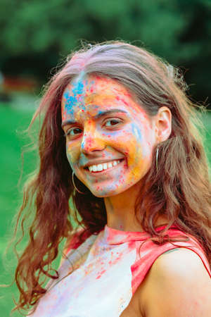 caucasian woman portrait in traditional indian holi festival paints