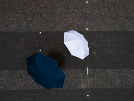 man and woman with umbrella view from above copy spaceの写真素材