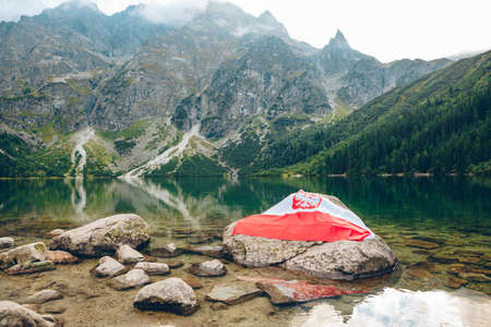 poland flag at the beach of mountains lake landscape scenic viewの写真素材