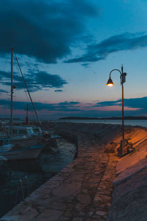 city light at quay. twilight over sea bay. copy spaceの写真素材