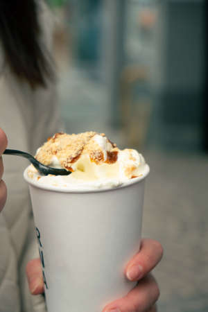 coffee with ice cream caramel on the top drink to goの写真素材