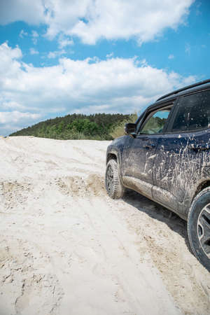 suv cars overcoming sand barrier. off road concept. copy space
