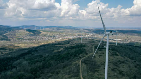 wind turbines green renewable electric energy sky clouds