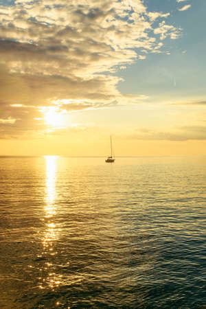 view of sail boat on sunset in bay. summer vacation. copy spaceの写真素材