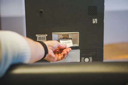 man taking ticket in front of underground parking barrier copy spaceの写真素材