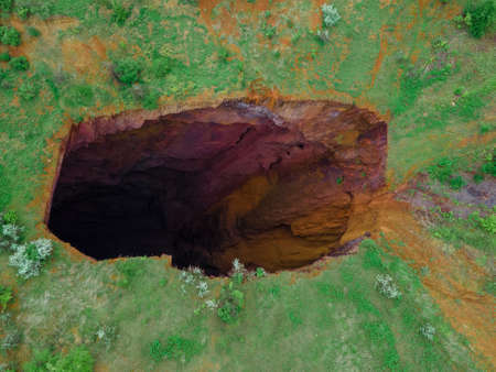 overhead view of collapsed mine big hole in landの写真素材