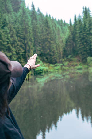 woman enjoying view of wild lake in mountains copy spaceの写真素材