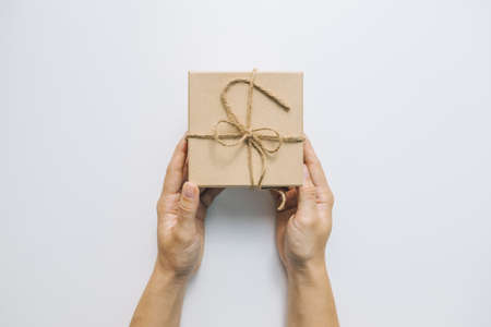 hand giving decorated present box celebration concept copy spaceの写真素材