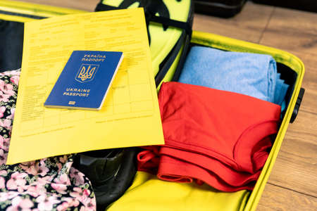 ukraine covid passport vaccination at bags with stuff ready for summer travelの写真素材