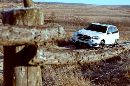 suv car near farm field fence copy space