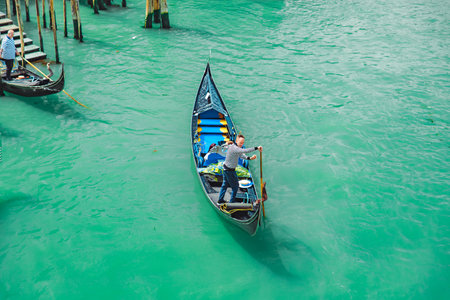 Venice, Italy - May 25, 2019: overhead view of gondola with tourist at grand canal. summer vacationの写真素材