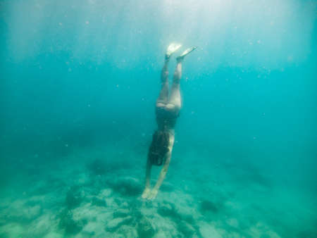 woman in snorkeling mask underwater summer sea vacationの写真素材