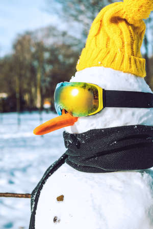 snow man with ski goggles close upの写真素材