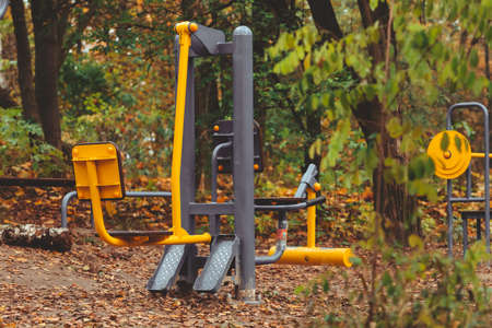 body builder simulators trainer outdoors in autumn city park copy spaceの写真素材