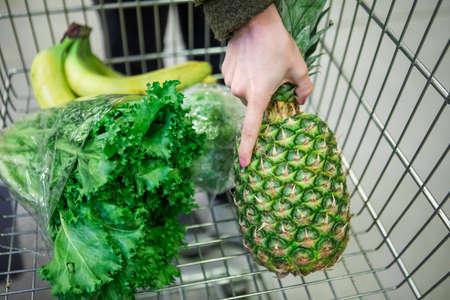 fruits and vegetables in grocery store cart copy spaceの写真素材