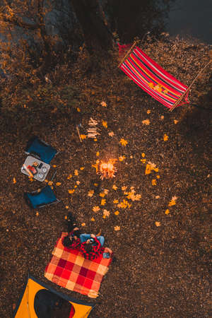 overhead top view of autumn camping site with tent car hammock bonfireの写真素材