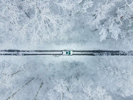 view of the white car from above in frozen winter forest copy spaceの写真素材