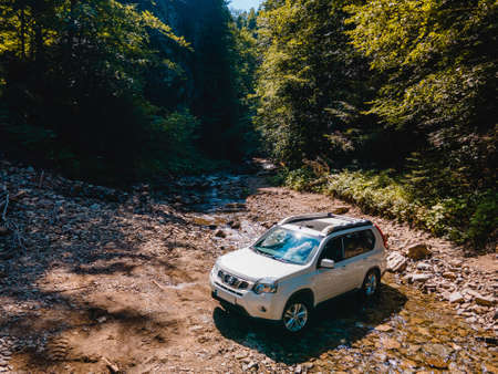 suv car mountains creek on background copy spaceの写真素材