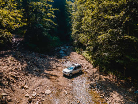 suv car mountains creek on background copy spaceの写真素材