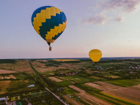 view of air balloon with basket flies on sunset copy space