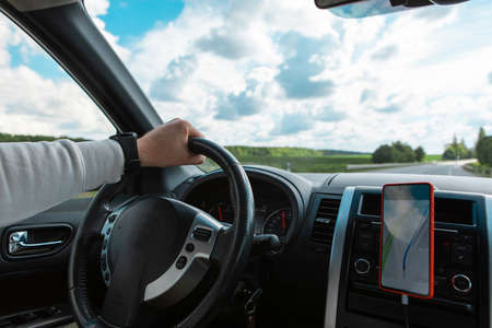 man hands on steering wheel cloudy sunny day copy spaceの写真素材