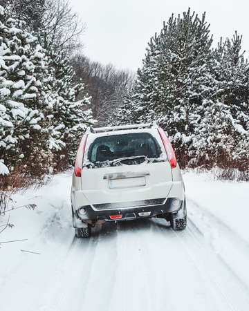 suv car in snowed forest copy spaceの写真素材