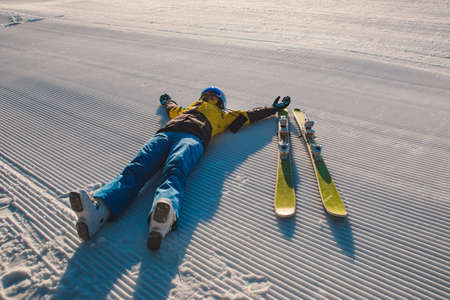 happy woman laying down on morning velvet with ski copy spaceの写真素材