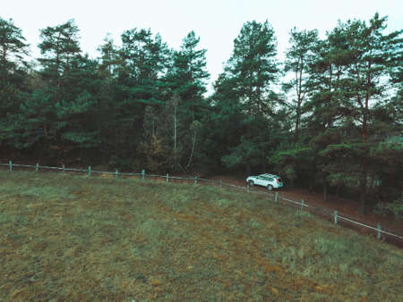 aerial view of suv car near farm fenceの写真素材