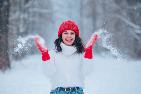 beautiful woman portrait outdoors in snowed forestの写真素材