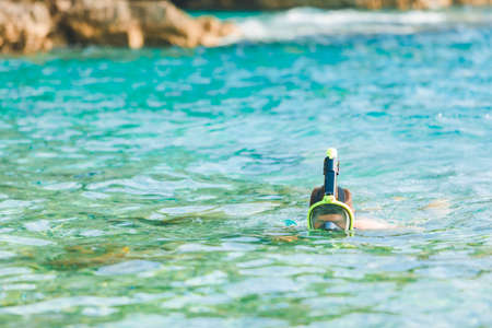 man swimming with snorkeling mask at blue azure sea water copy spaceの写真素材
